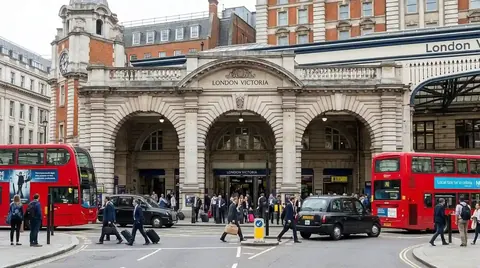Red buses outside the entrance to Victoria station